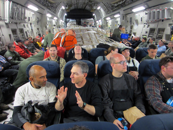 View of the inside of the C-17 aircraft during the flight from Christchurch, New Zealand, to McMurdo Station, Antarctica. Murat Aydin (left; South Pole Ice Core Chief Scientist) talks with Eric Saltzman (center; Section Head, Antarctic Sciences, NSF) Credit: Joe Souney